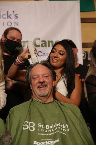 Phil Ralston gets his head shaved by his daughter,