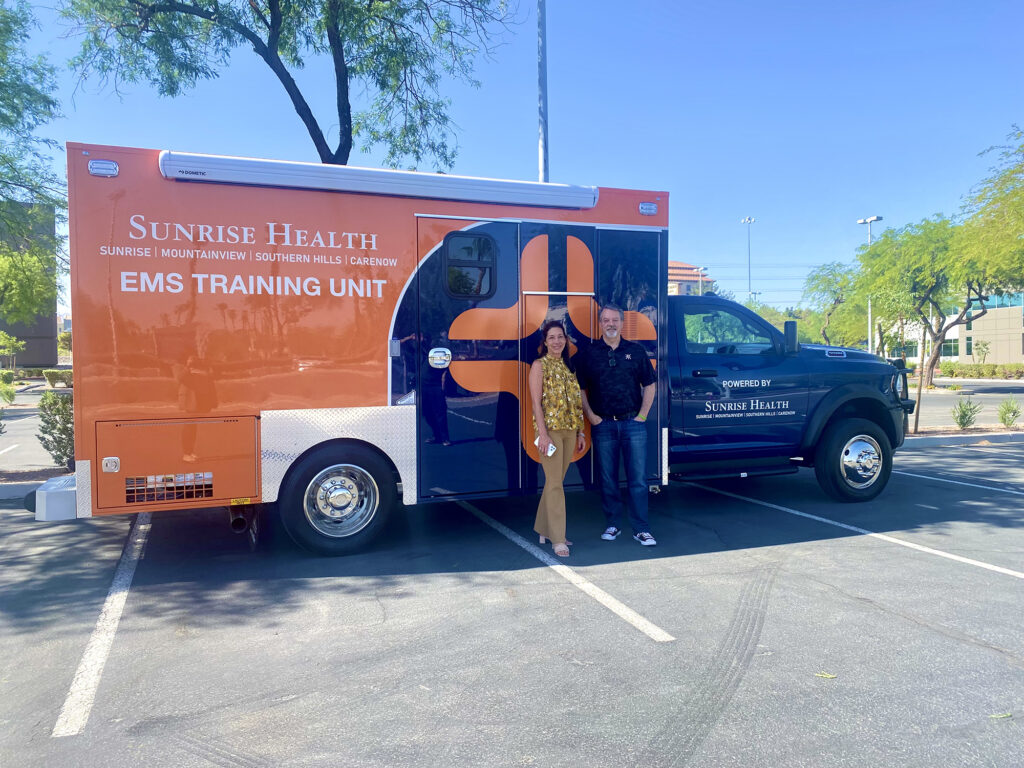 Phil Ralston and Natlie Allred withSunrise Health System’s new EMS Training Unit and Ambulance