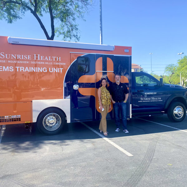 Phil Ralston and Natlie Allred withSunrise Health System’s new EMS Training Unit and Ambulance