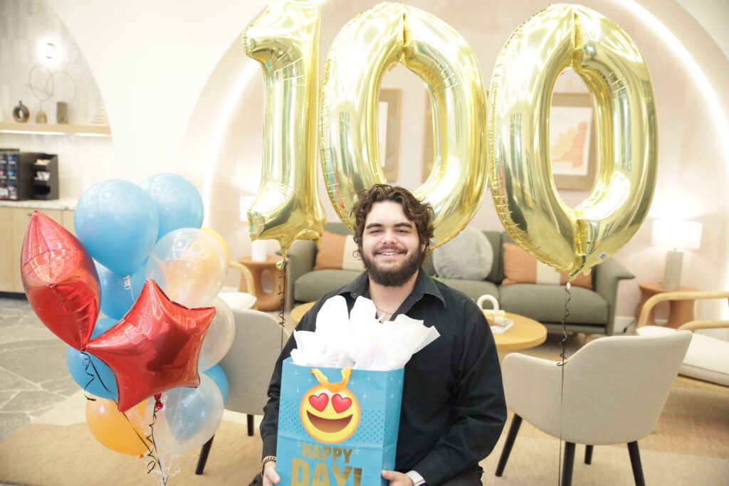 Jonathan Sanchez standing in front of "100" balloons
